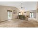 Large and bright living room featuring vaulted ceilings, neutral tones, and a ceiling fan at 506 E E St, Butner, NC 27509