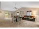 Bright living room with vaulted ceilings, comfortable seating, and a sliding glass door to the deck at 506 E E St, Butner, NC 27509