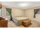 Spacious bedroom with neutral walls, carpet flooring, and natural light from two windows at 506 E E St, Butner, NC 27509