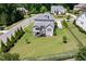 Aerial view of landscaped backyard featuring a deck and mature trees at 5100 Schellinger, Raleigh, NC 27612