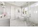 Bright bathroom featuring marble floors, walk-in shower, and a luxurious soaking tub at 5100 Schellinger, Raleigh, NC 27612