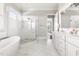 Bright bathroom featuring marble floors, walk-in shower, and a luxurious soaking tub at 5100 Schellinger, Raleigh, NC 27612
