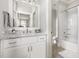 Well-lit bathroom with a marble countertop vanity and a shower-tub combination at 5100 Schellinger, Raleigh, NC 27612