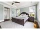 Large bedroom with neutral paint, hardwood floors, large windows, and a wooden bedframe at 5100 Schellinger, Raleigh, NC 27612