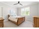 Cozy bedroom featuring a wooden sleigh bed, soft carpeting, and ample natural light at 5100 Schellinger, Raleigh, NC 27612