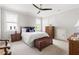Comfortable bedroom with a ceiling fan, ample natural light, and classic wooden furniture at 5100 Schellinger, Raleigh, NC 27612