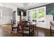 Dining room featuring a coffered ceiling, large windows, and a stylish chandelier over a wooden table at 5100 Schellinger, Raleigh, NC 27612