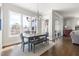 Dining room with a wooden table, blue chairs, and large windows providing natural light at 5100 Schellinger, Raleigh, NC 27612