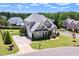Aerial view of home with well-manicured lawn, mature trees, and a three car garage at 5100 Schellinger, Raleigh, NC 27612