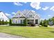 Charming two-story home with a well-manicured lawn, beautiful landscaping, and a welcoming front porch at 5100 Schellinger, Raleigh, NC 27612
