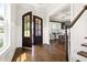 Elegant foyer with hardwood floors, showcasing the entry to the dining room and beautiful staircase at 5100 Schellinger, Raleigh, NC 27612