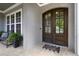 Beautiful double front doors with glass inserts, complemented by a stone porch and potted plants at 5100 Schellinger, Raleigh, NC 27612
