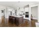 Bright kitchen with marble countertops, stainless steel appliances and a dark wood island with seating at 5100 Schellinger, Raleigh, NC 27612
