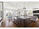 Open kitchen with large island, stainless steel sink and appliances, and eat-in dining area with lots of light at 5100 Schellinger, Raleigh, NC 27612