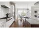 Open Kitchen with stainless steel appliances, marble countertops, modern white cabinetry, and attached dining area at 5100 Schellinger, Raleigh, NC 27612