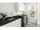 Convenient laundry room with modern washer and dryer, sink, and white cabinetry at 5100 Schellinger, Raleigh, NC 27612