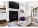 Living room with a cozy fireplace, built-in shelves, and elegant decor at 5100 Schellinger, Raleigh, NC 27612