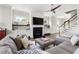 Comfortable living room with a fireplace, built-in shelving, and a view of the staircase at 5100 Schellinger, Raleigh, NC 27612