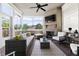 Cozy screened-in porch with brick fireplace, wicker seating, ceiling fan, and lots of natural light at 5100 Schellinger, Raleigh, NC 27612