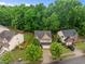 Aerial view showcasing a home with mature trees and a spacious backyard at 552 Stobhill Ln, Holly Springs, NC 27540