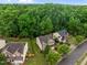 Aerial view showcasing a home with mature trees and a spacious backyard at 552 Stobhill Ln, Holly Springs, NC 27540