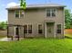 The home's back exterior features an outdoor pergola, a patio, and a lush green lawn at 552 Stobhill Ln, Holly Springs, NC 27540