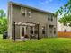 The home's back exterior features an outdoor pergola, a patio, and a large grassy yard at 552 Stobhill Ln, Holly Springs, NC 27540