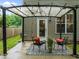 Cozy covered back patio seating area with string lights and outdoor rug at 552 Stobhill Ln, Holly Springs, NC 27540