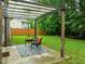 Inviting backyard patio with seating area, pergola, and lush green lawn at 552 Stobhill Ln, Holly Springs, NC 27540