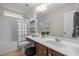 Well-lit bathroom featuring a white vanity, framed mirror, and tub with shower at 552 Stobhill Ln, Holly Springs, NC 27540