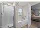 Modern bathroom features a separate shower and tub, offering a spa-like experience at 552 Stobhill Ln, Holly Springs, NC 27540