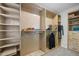 Spacious walk-in closet with custom wood shelving for optimal organization and storage at 552 Stobhill Ln, Holly Springs, NC 27540
