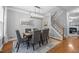 Elegant dining room featuring a modern chandelier and a staircase in view at 552 Stobhill Ln, Holly Springs, NC 27540