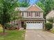 Charming two-story home with stone accents and a well-manicured lawn at 552 Stobhill Ln, Holly Springs, NC 27540