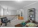 Bright hallway with a stylish chandelier, open staircase, and convenient access to laundry room at 552 Stobhill Ln, Holly Springs, NC 27540