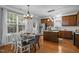 Bright kitchen and dining area featuring stainless steel appliances and hard wood floors at 552 Stobhill Ln, Holly Springs, NC 27540
