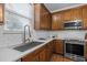 The kitchen has wood cabinets, stainless steel appliances, and a bright subway tile backsplash at 552 Stobhill Ln, Holly Springs, NC 27540