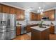 Beautiful kitchen featuring stainless steel appliances, wooden cabinets, island, and hardwood floors at 552 Stobhill Ln, Holly Springs, NC 27540