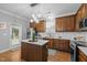 Well-equipped kitchen with center island, stainless steel appliances and modern lighting at 552 Stobhill Ln, Holly Springs, NC 27540