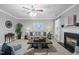 Inviting living room with fireplace, ceiling fan, and comfortable seating at 552 Stobhill Ln, Holly Springs, NC 27540
