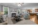 Open concept living room with fireplace and view into the dining and kitchen at 552 Stobhill Ln, Holly Springs, NC 27540