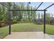 Backyard featuring green grass, a wooden privacy fence, a trampoline and an overhead trellis at 60 Silent Brook Trl, Franklinton, NC 27525