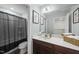This bathroom has a single sink vanity, a large mirror, and a shower with dark curtains at 60 Silent Brook Trl, Franklinton, NC 27525