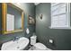 Stylish powder room featuring green walls, an ornate mirror, and modern fixtures at 60 Silent Brook Trl, Franklinton, NC 27525