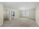 The carpeted bedroom has an open doorway to another room, and natural light from windows at 60 Silent Brook Trl, Franklinton, NC 27525