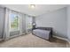 This bedroom features carpet, neutral walls, natural light from two windows, and a daybed at 60 Silent Brook Trl, Franklinton, NC 27525