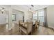 Dining room with a modern chandelier and large windows that provide lots of natural light at 60 Silent Brook Trl, Franklinton, NC 27525