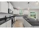 Bright kitchen with white cabinets, granite countertops, and an island with a sink at 60 Silent Brook Trl, Franklinton, NC 27525