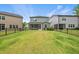 Large backyard with a black fence and neighboring houses at 6036 Balance Ct, Raleigh, NC 27616