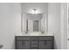 Bright bathroom with gray cabinets, double sink vanity and large mirror at 6036 Balance Ct, Raleigh, NC 27616